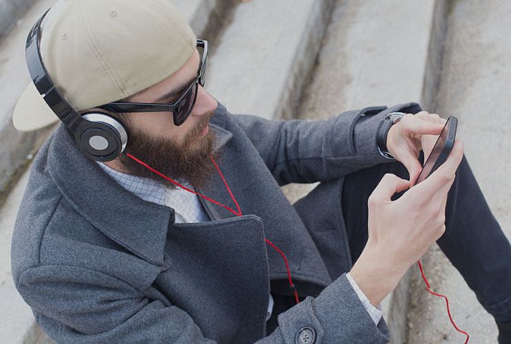 Man with Headphones Sitting on Stairs Man with Headphones Sitting on Stairs